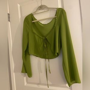 Never worn green blouse. Ties in the front and is sheer. Purchased from Luna B